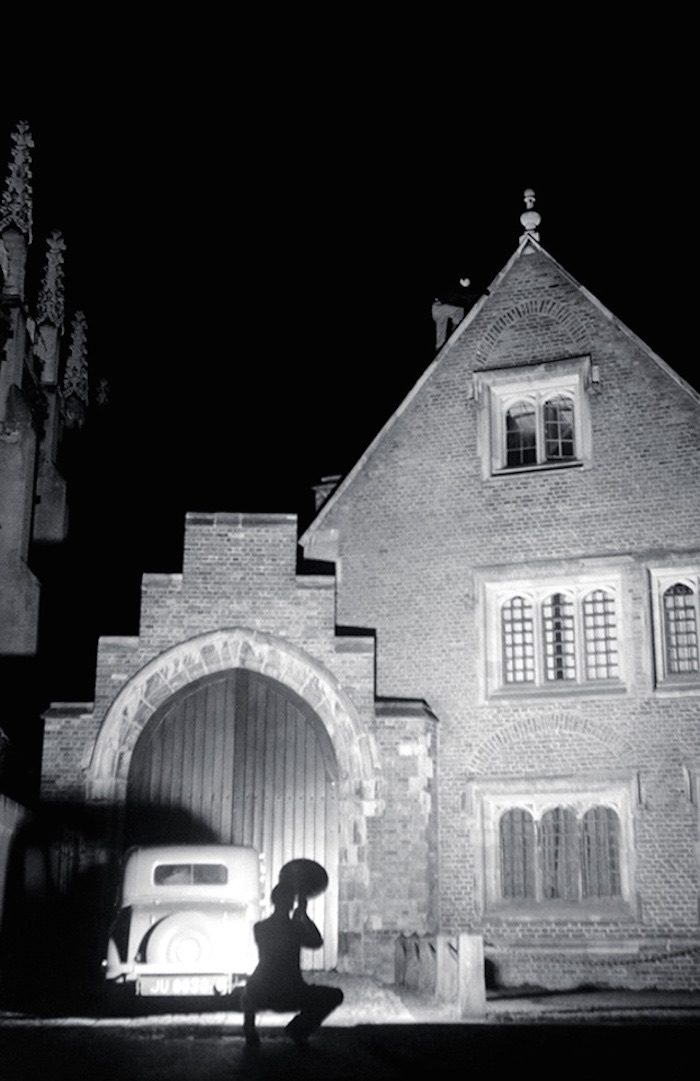 Climbers on a college roof at night, photographed by flash